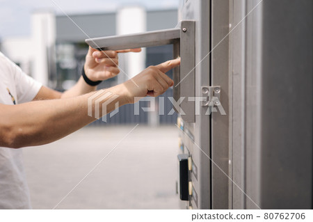 Closeup of man put cart for washing car. Man chosse spray Closeup of man put cart for washing car. Man chosse spray 80762706