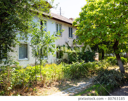 old shabby two-storey municipal house in town old shabby two-storey municipal house in town 80763185