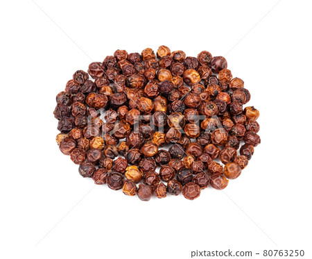 handful of red Kampot pepper closeup on white 80763250