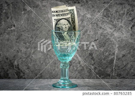 Wineglass with one dollar inside Wineglass with one dollar inside 80763285