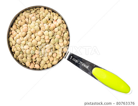 whole light green lentils in measuring cup cutout 80763376