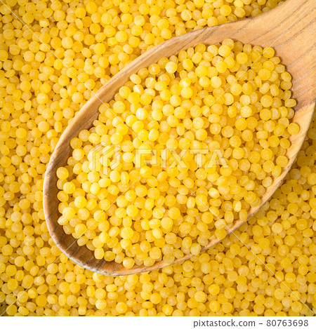 ptitim (Israeli couscous) in wooden spoon closeup 80763698