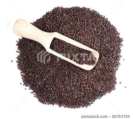 top view of scoop on pile of black mustard seeds 80763704