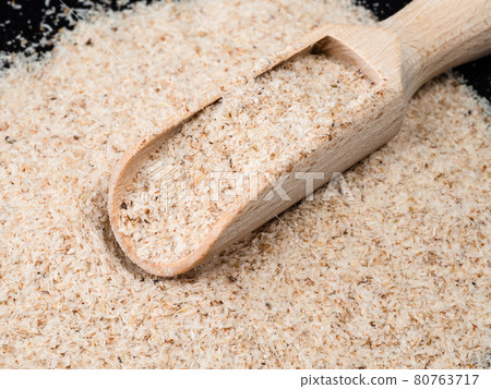 wooden scoop in Psyllium husk close up wooden scoop in Psyllium husk close up 80763717