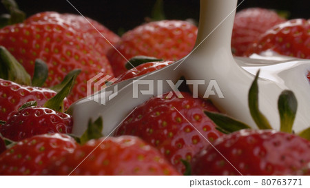 Yogurt pouring onto strawberries 80763771