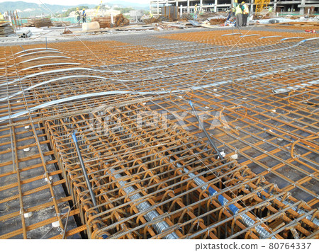 MALACCA, MALAYSIA -APRIL 14, 2016: Pre-stress cable laid in round ducting install in between the slab steel reinforcement bar at the construction site. MALACCA, MALAYSIA -APRIL 14, 2016: Pre-stress cable laid in round ducting install in between the slab steel reinforcement bar at the construction site. 80764337