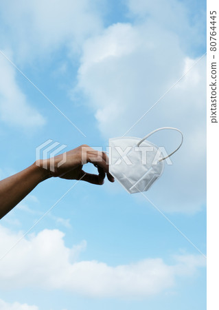 man holds a FFP2 face mask in his hand man holds a FFP2 face mask in his hand 80764445