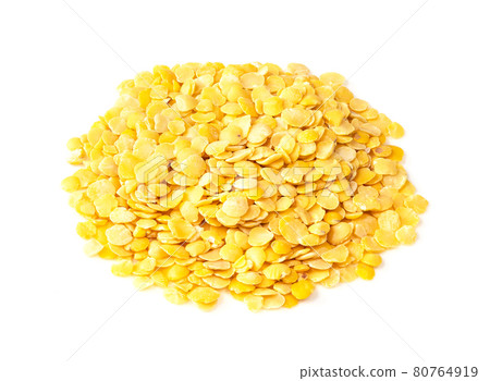 pile of split yellow lentils closeup on white 80764919