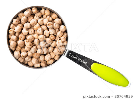 chickpea seeds in measuring cup cutout 80764939