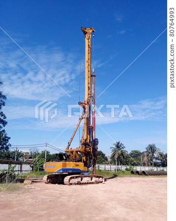 MALACCA, MALAYSIA -MARCH 12, 2016: Bore pile rig machine at the construction site in Malacca, Malaysia. The machine used to driven pile for building foundation work. MALACCA, MALAYSIA -MARCH 12, 2016: Bore pile rig machine at the construction site in Malacca, Malaysia. The machine used to driven pile for building foundation work. 80764993