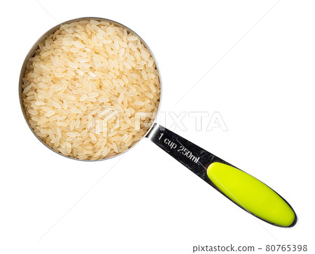 parboiled rice in measuring cup cutout on white parboiled rice in measuring cup cutout on white 80765398