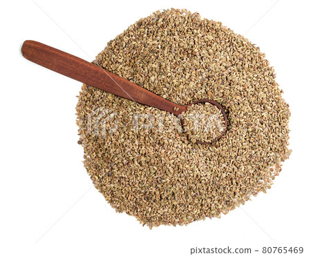 top view of wood spoon on ajowan fruits on white top view of wood spoon on ajowan fruits on white 80765469