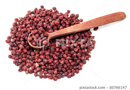 spoon on pile of dried magnolia berries on white 80766147