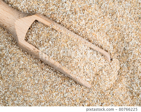 top view of wooden scoop in rye bran top view of wooden scoop in rye bran 80766225