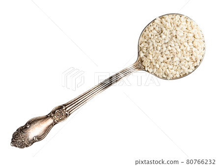 top view of white sesame seeds in spoon cutout 80766232