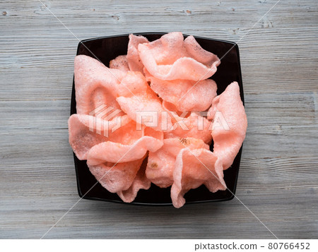 top view of shrimp chips in black bowl on table 80766452