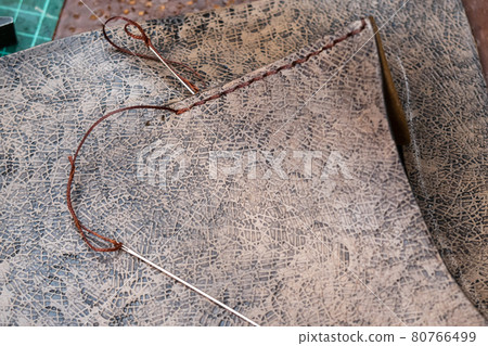needles with thread near stitch on leather handbag needles with thread near stitch on leather handbag 80766499