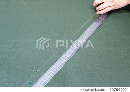 craftsman draws a pattern on leather using ruler craftsman draws a pattern on leather using ruler 80766501