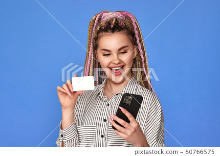 woman making online payment through mobile phone via credit card 80766575