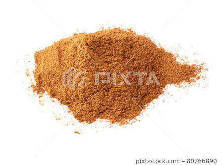 handful of cinnamon powder closeup on white 80766890