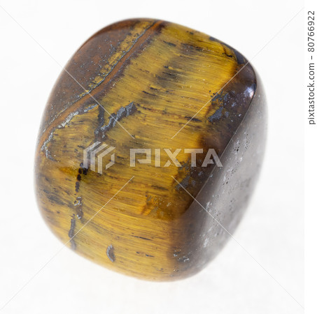 polished tiger eye (tiger-eye) gem stone on white polished tiger eye (tiger-eye) gem stone on white 80766922