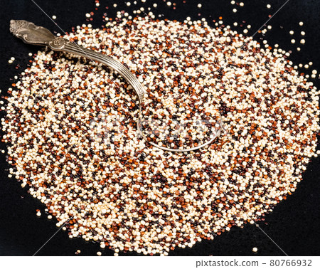 tablespoon in mix of quinoa seeds on black 80766932