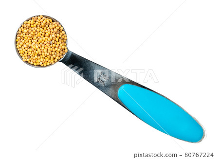 yellow seeds of oriental mustard in spoon cutout yellow seeds of oriental mustard in spoon cutout 80767224