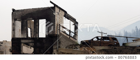 Fire Debris of Houses in a small town with smoke in sky. Fire Debris of Houses in a small town with smoke in sky. 80768883