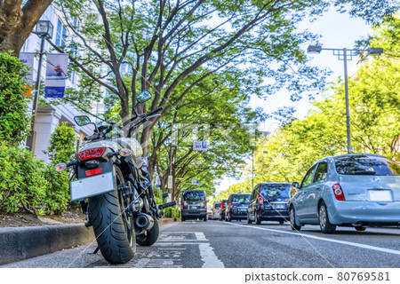 Motorcycles parked in the street parking lot of Tokyo Touring Omotesando 80769581