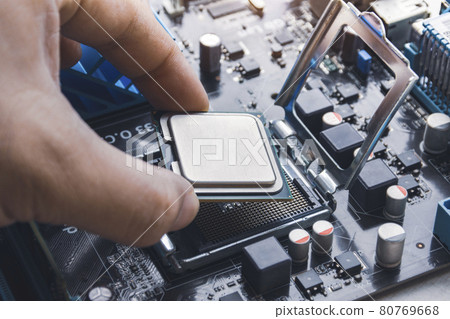Technician install CPU processor chip in socket on computer motherboard Technician install CPU processor chip in socket on computer motherboard 80769668