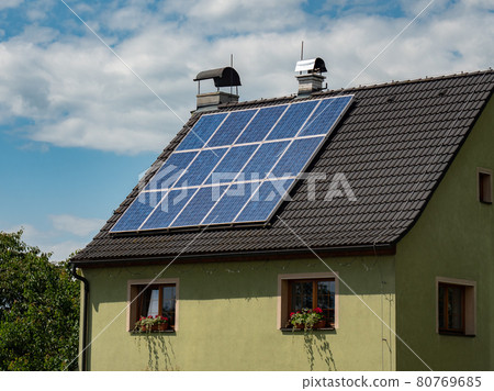 Common solar panels on modern roof with dark blue photocell Common solar panels on modern roof with dark blue photocell 80769685
