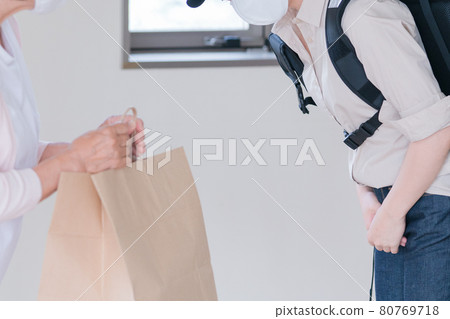 Senior woman receiving a delivery order Senior woman receiving a delivery order 80769718