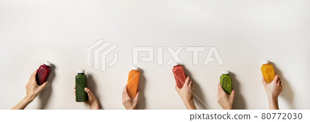 Human hands holding fresh juices in bottles, copy Human hands holding fresh juices in bottles, copy 80772030