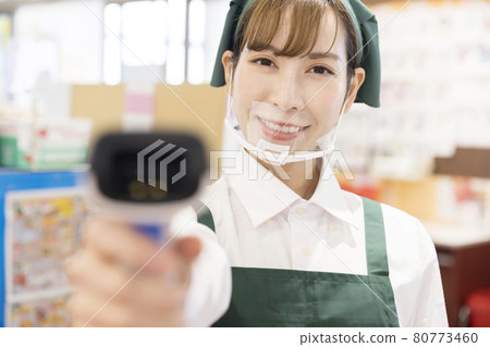 在通過收銀台控制感染的超市收銀員工作的女員工 在通過收銀台控制感染的超市收銀員工作的女員工 80773460