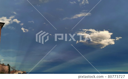Fantastic sky at dusk with clouds on trails of light that depart from the sea like comets Fantastic sky at dusk with clouds on trails of light that depart from the sea like comets 80773727