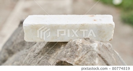 stone podium on a gray rocky background 80774819