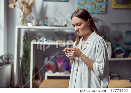 Young caucasian happy seller woman at botanic shop Young caucasian happy seller woman at botanic shop 80775203