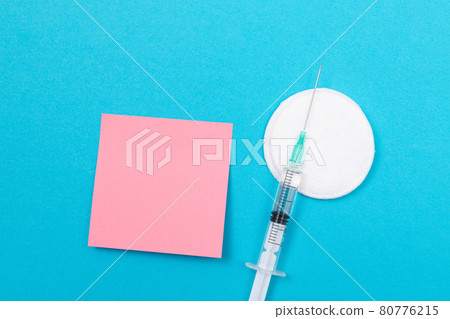 Vaccination or Revaccination Concept - A Medical Syringe on Blue Table 80776215