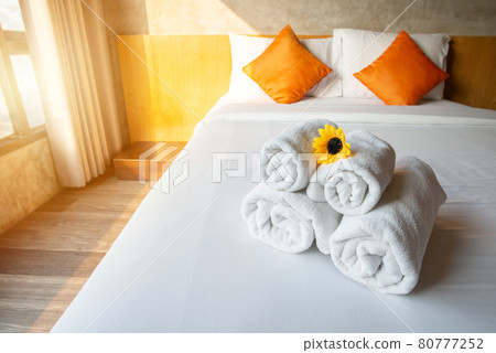 Set of towels on comfortable Double bed in bedroom decoration in cozy style. Conceptual of a room in a home where people sleep. Set of towels on comfortable Double bed in bedroom decoration in cozy style. Conceptual of a room in a home where people sleep. 80777252