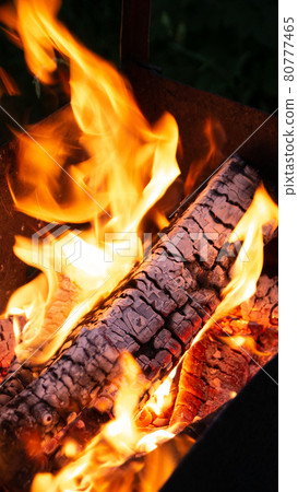 Burning firewood in the fireplace close up. 80777465