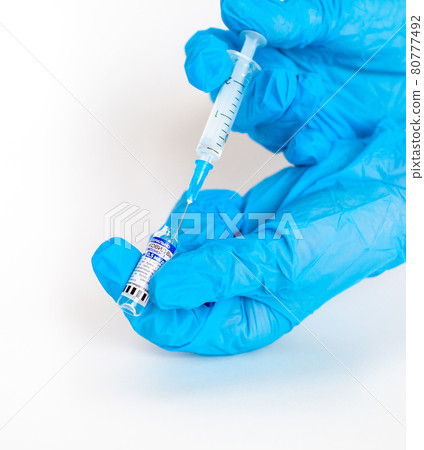 The coronavirus vaccine is in the hands of a doctor, a syringe The coronavirus vaccine is in the hands of a doctor, a syringe 80777492