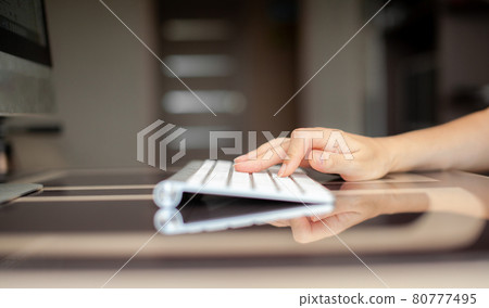 Female hands typing text on the keyboard while exchanging messages Female hands typing text on the keyboard while exchanging messages 80777495