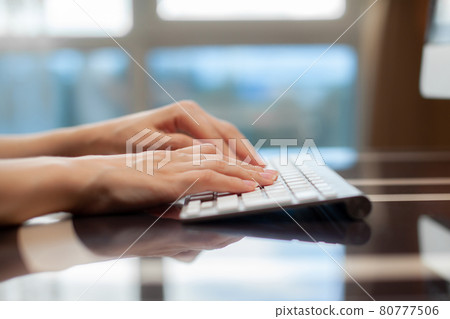 Female hands typing text on the keyboard while exchanging messages Female hands typing text on the keyboard while exchanging messages 80777506