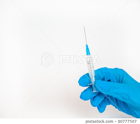 The doctor holds a vaccination syringe on a white background. The doctor holds a vaccination syringe on a white background. 80777507