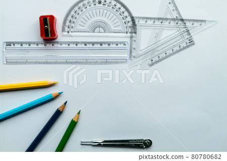 Geometric Measuring tools, Drawing items and mathematical instruments placed on white paper sheet. Back to school and Engineering education learning background. Empty Copy space room for text. 80780682