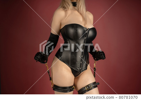 Beautiful young woman in a leather corset and bondage set posing Beautiful young woman in a leather corset and bondage set posing 80781070