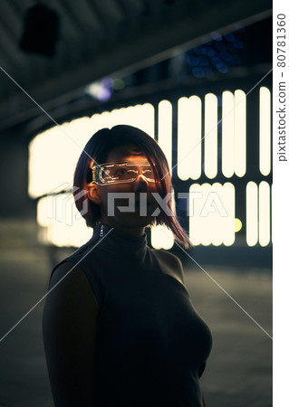 Cyberpunk style portrait of beautiful young woman in futuristic costume. Cyberpunk style portrait of beautiful young woman in futuristic costume. 80781360