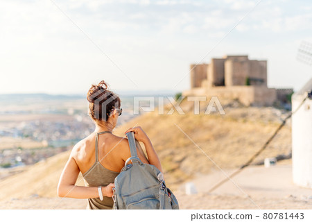Woman in a hill with a medieval castle 80781443