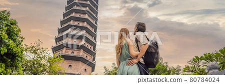 BANNER, LONG FORMAT Man and woman tourists in Temple tower of Bai Dinh pagoda in Ninh Binh, Vietnam. Resumption of tourism in Vietnam after quarantine Coronovirus COVID 19 BANNER, LONG FORMAT Man and woman tourists in Temple tower of Bai Dinh pagoda in Ninh Binh, Vietnam. Resumption of tourism in Vietnam after quarantine Coronovirus COVID 19 80784024