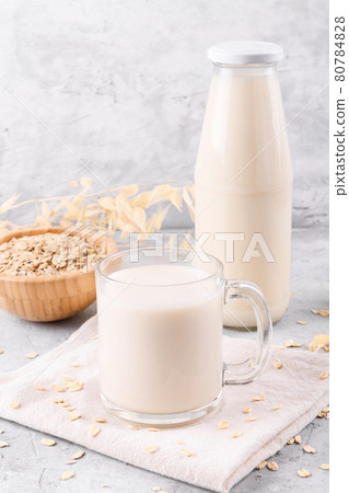 Vegan non dairy alternative milk. Oat milk on grey stone table 80784828